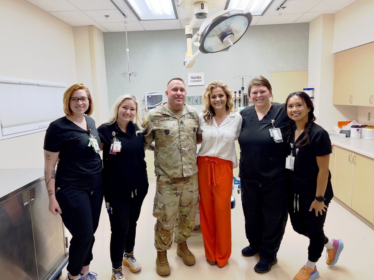 Sgt. Russell Stierlen with his wife Ashlei and ER staff.